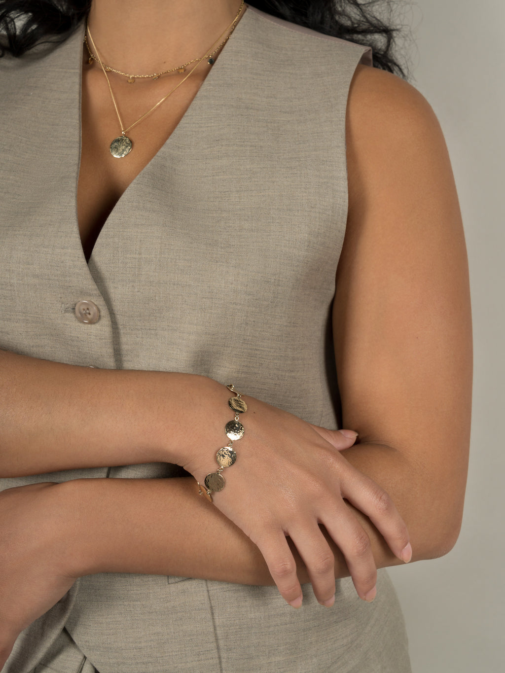 Lavey London's Solid 9ct Gold Hammered Disc Pendant, Drop Charm Chocker and Hammered Disc Bracelet Shown on Model