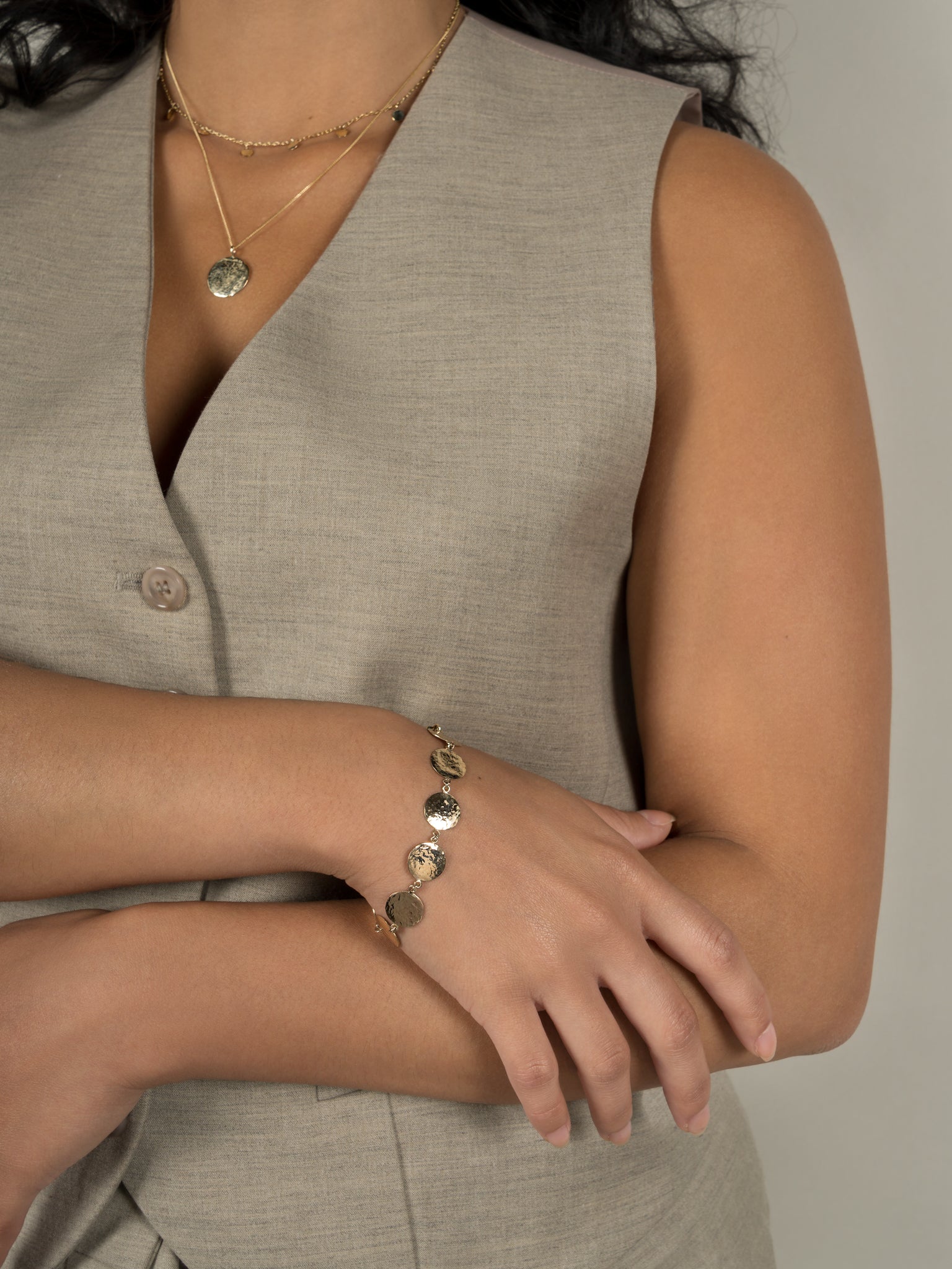 Lavey London's Solid 9ct Gold Hammered Disc Pendant, Drop Charm Chocker and Hammered Disc Bracelet Shown on Model