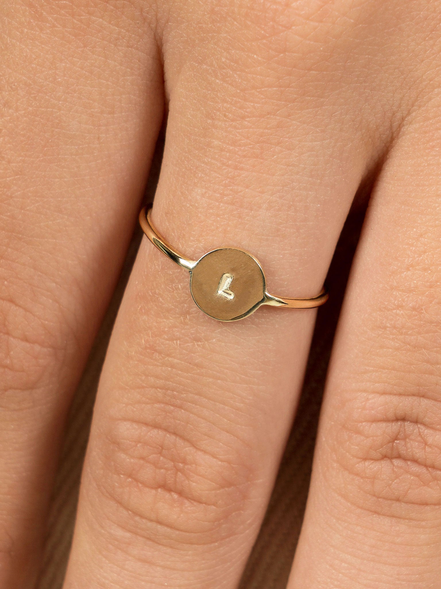Close up photo of hand shows Lavey London's Solid 9ct Gold Personalised Disc Ring 