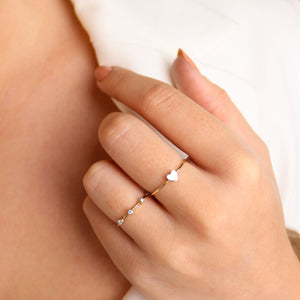 Model wears Lavey london's Solid 9ct Gold Diamond Bezel Set Half Eternity Band and Solid 9ct Gold Mini Love Heart Ring